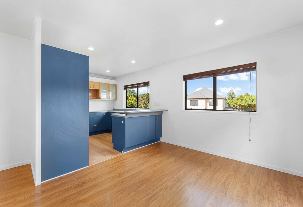 Bright and spacious kitchen and dining area in Rangitoto College Zone property with stylish flooring and recessed lighting.