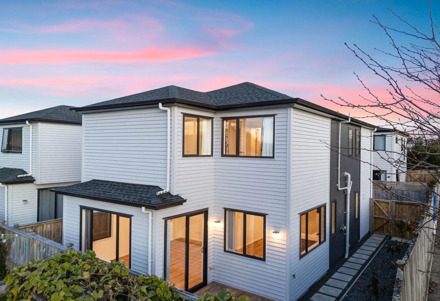 Modern two-storey weatherboard home at 5B Notre Dame Way with black trim and large windows, professionally marketed by real estate agent Albany.