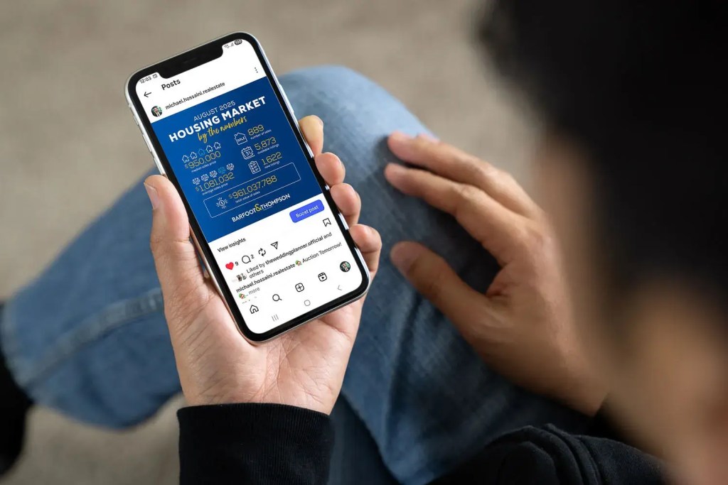 Reliable market reports for north shore real estate trends on mobile phone showing August 2025 housing statistics.