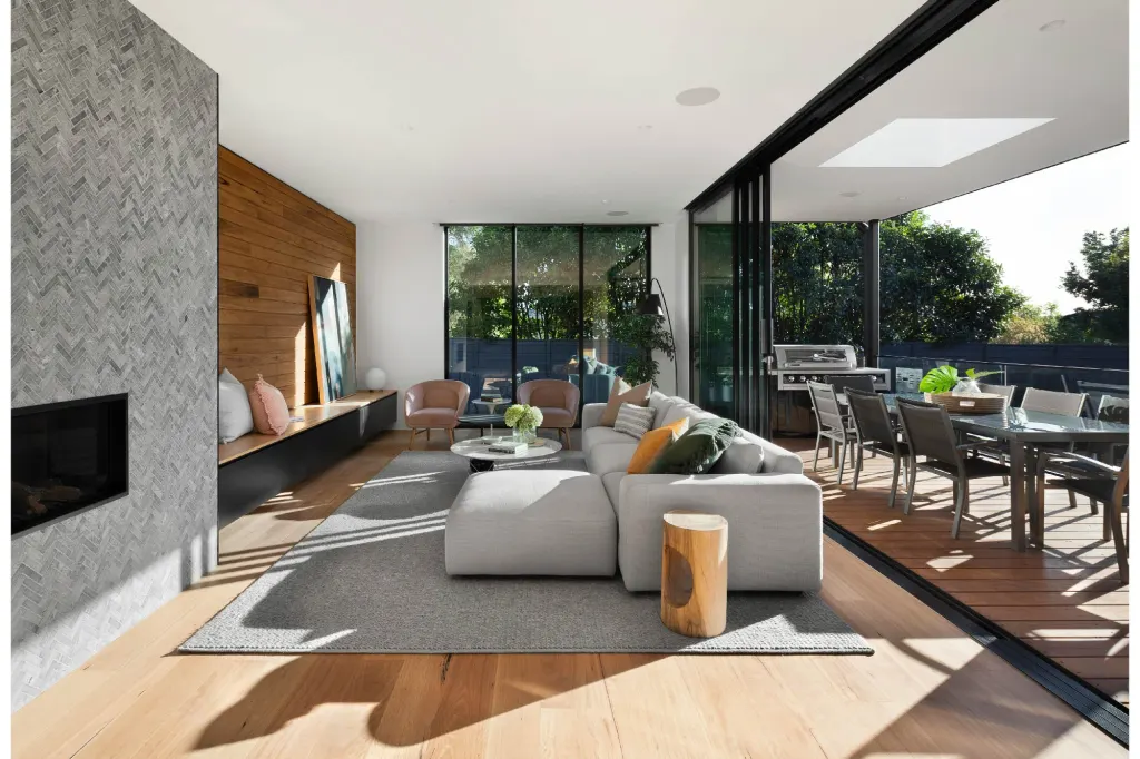 Bright modern living room and outdoor deck area in Auckland home — featured in a seller’s guide to listing your house in Auckland.