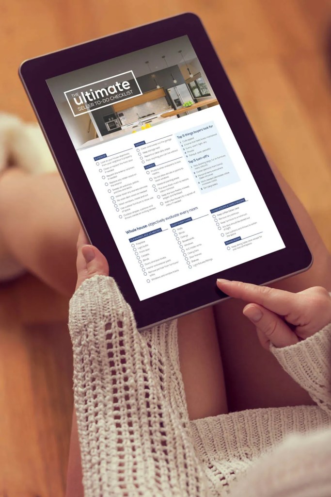 Person viewing the Ultimate Seller To-Do Checklist and real estate insights and market trends in New Zealand.