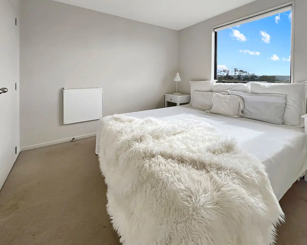 Peaceful double bedroom with large window and sky views – 12E Schnapper Rock Road.