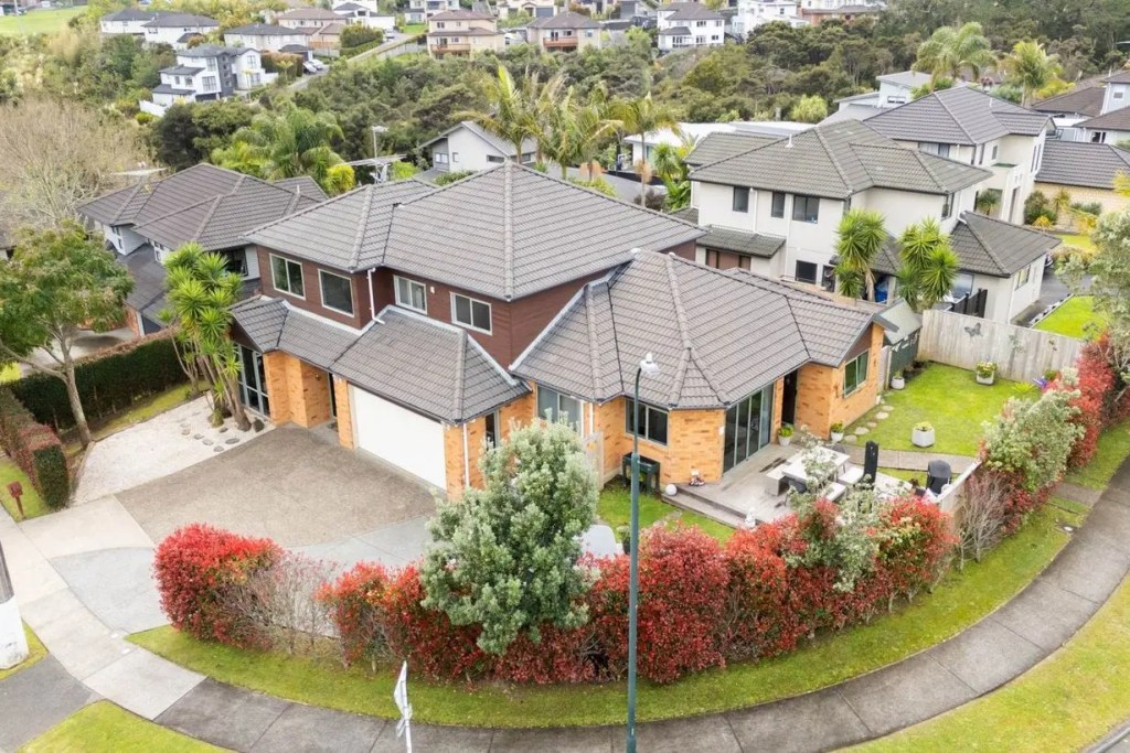 Large two-storey family home with tiled roof and landscaped corner section in Schnapper Rock, marketed by Real Estate Agent Schnapper Rock Michael Hossaini.