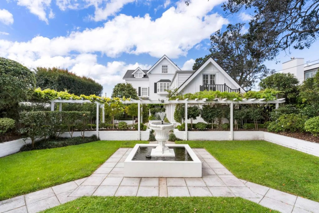 Elegant Takapuna character home with landscaped garden and fountain, marketed by a Real Estate Agent Takapuna.