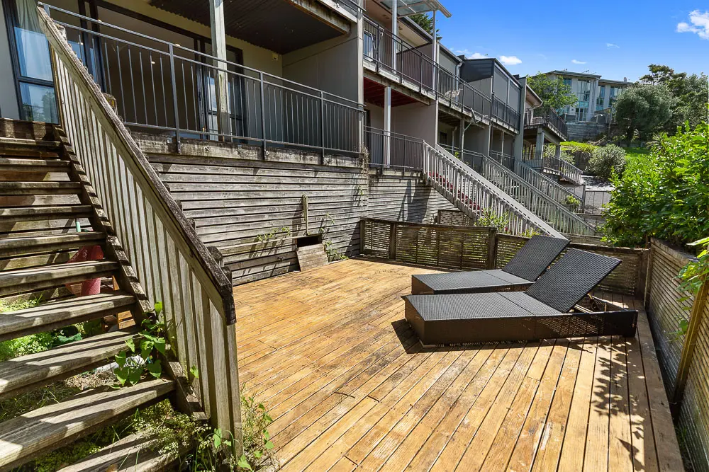 Private sun deck with loungers surrounded by greenery.