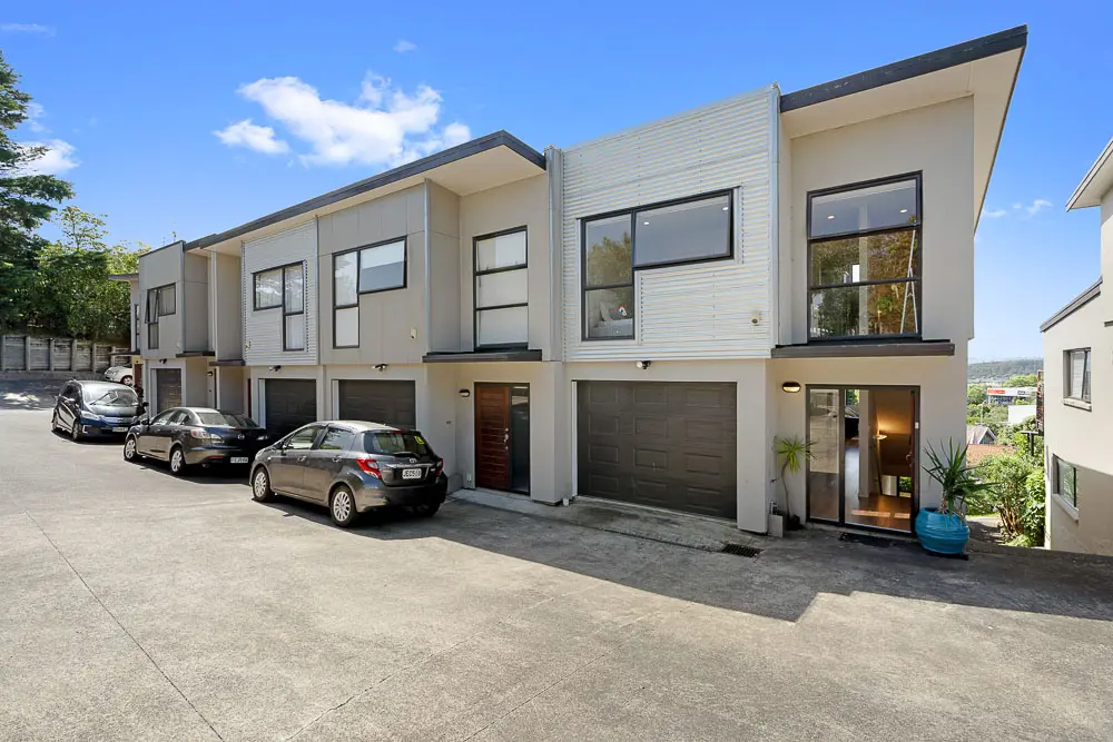 Modern townhouse exterior with internal access garage and entryway.