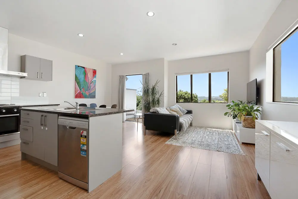 Open-plan kitchen, dining and lounge with elevated outlook at 12E Schnapper Rock Road.