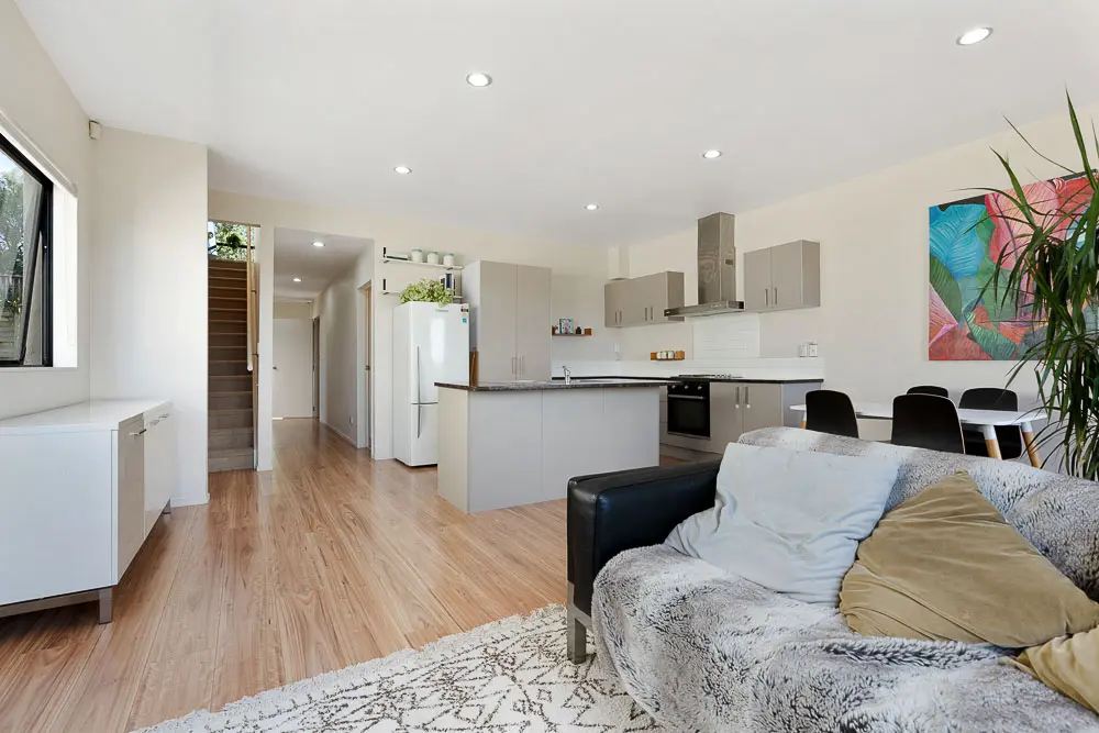 Open-plan dining, living and kitchen with island bench – 12E Schnapper Rock Road.