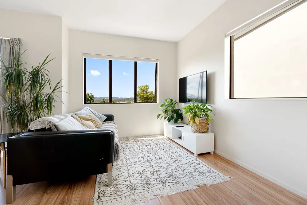Sunny living room with large picture windows and views – 12E Schnapper Rock Road.