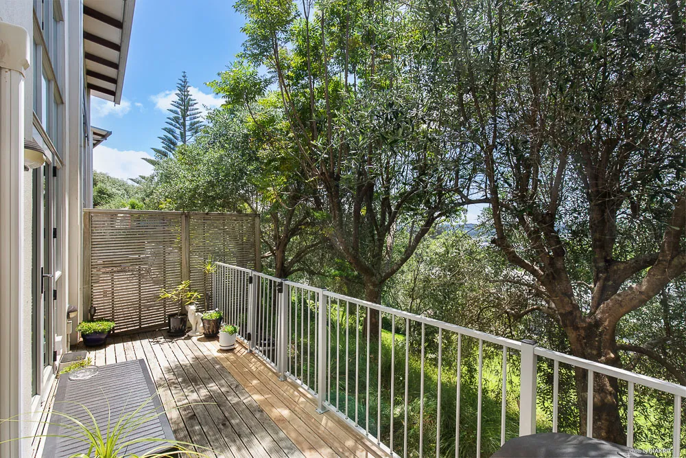 Private deck at 5-20 Schnapper Rock Road overlooking mature trees, lush greenery, and fully fenced outdoor space with natural sunlight.